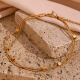  18K Gold Plated Waterproof Double Layer Anklet on stone background