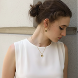 woman wearing Waterproof Blue Flower Necklace and Earrings Set – 18K Gold Plated