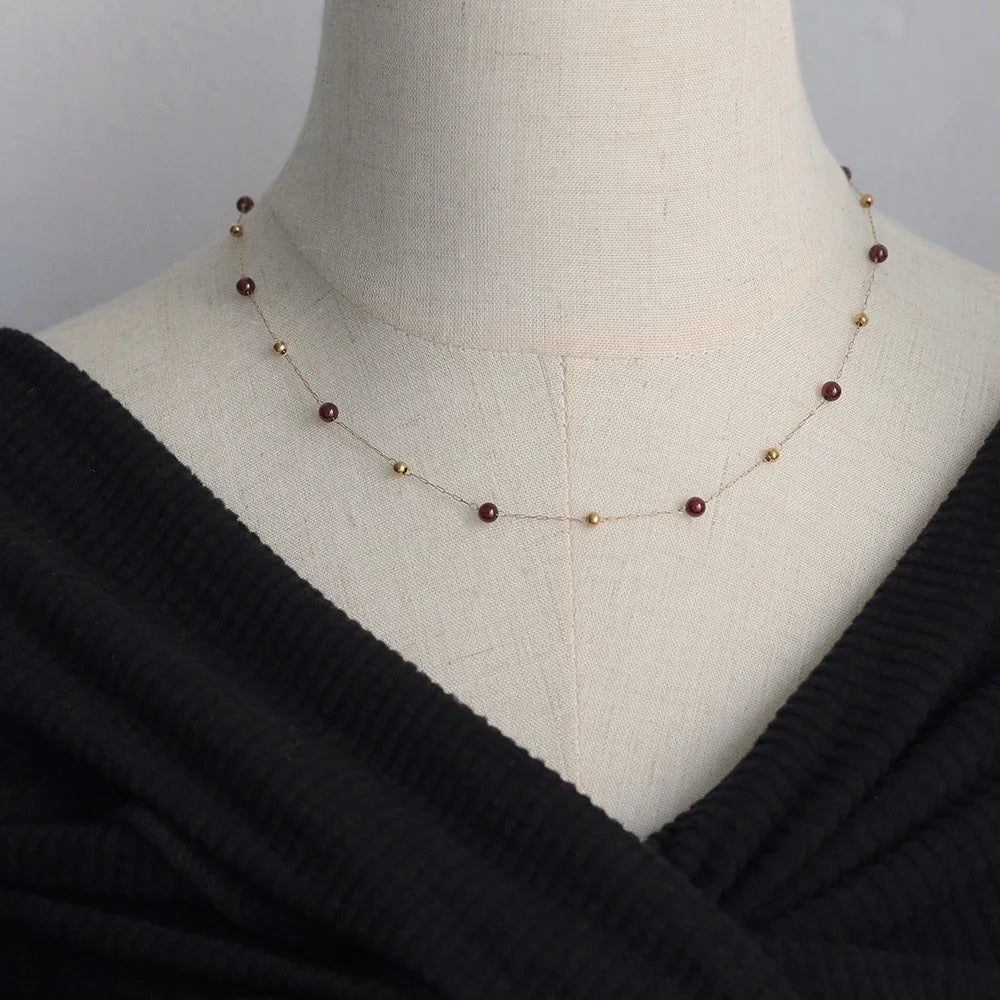Model wearing Gold Bead & Garnet Necklace Gold-Plated Stainless Steel