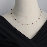 Model wearing Gold Bead & Garnet Necklace Gold-Plated Stainless Steel