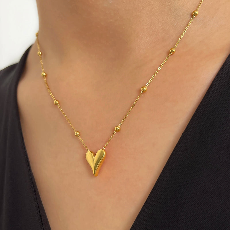 Model wearing Dainty Love Heart Bead Chain Necklace in 18K yellow Gold-Plated Stainless Steel