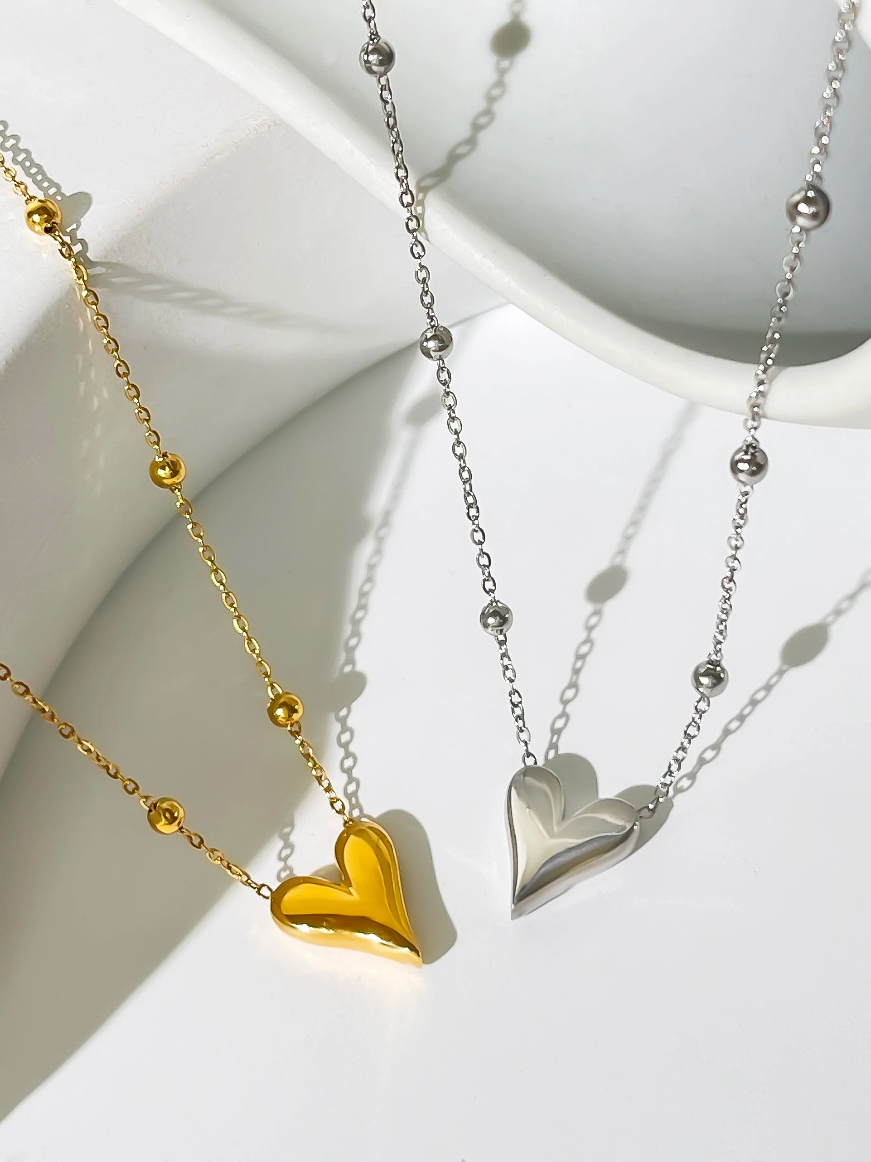Two side by side Dainty Love Heart Bead Chain Necklace in 18K yellow and white Gold-Plated Stainless Steel options