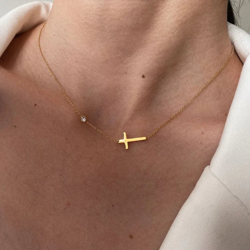model wearing Waterproof Gold Cross Necklace and Bracelet set