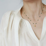 Model wearing Waterproof Green Bead Shell Pendant Necklace. Crafted with 18K gold-plated stainless stee