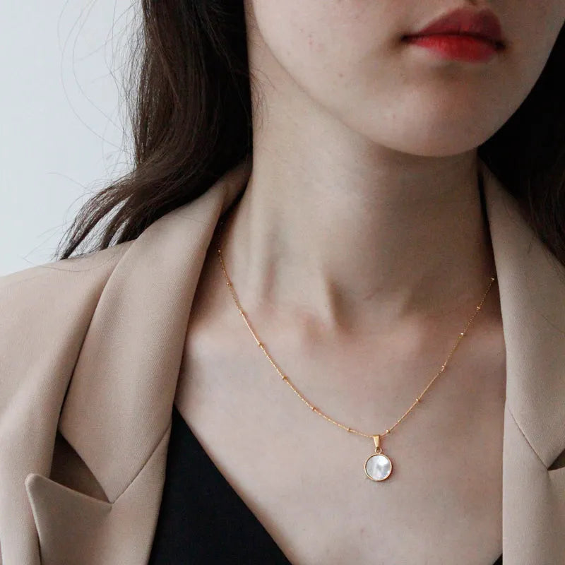 model wearing Waterproof White Shell Geometric Pendant Necklace in 18k Gold-Plated Stainless Steel - round