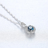 Halo Pendant Necklace in Sterling Silver and Blue Stone