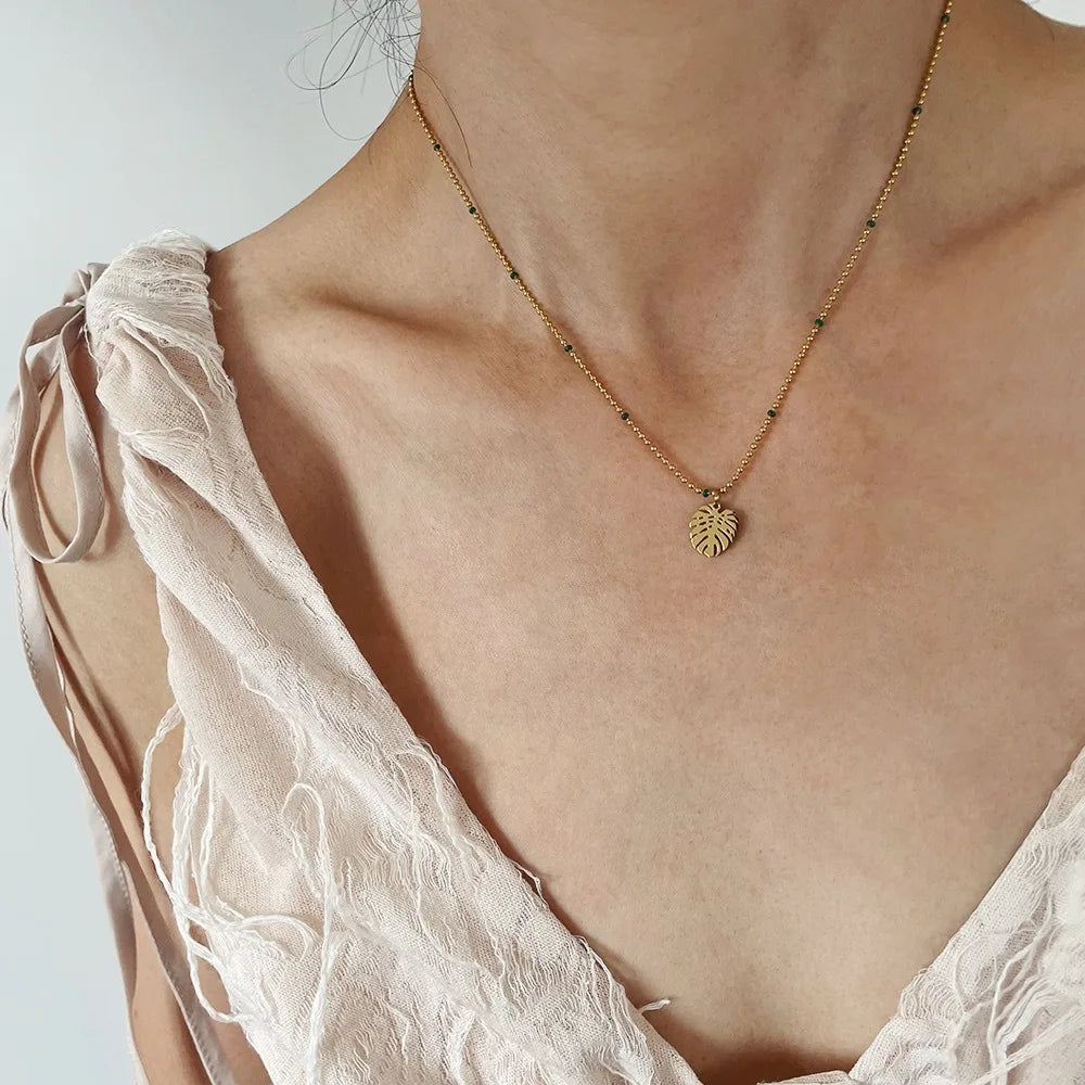 Model wearing Elegant 18K Gold Leaf Pendant Necklace Plated Stainless Steel