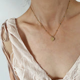 Model wearing Elegant 18K Gold Leaf Pendant Necklace Plated Stainless Steel
