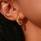 Model wearing LillyFleur Waterproof Twisted Hoop Earrings - 18K Gold Plated