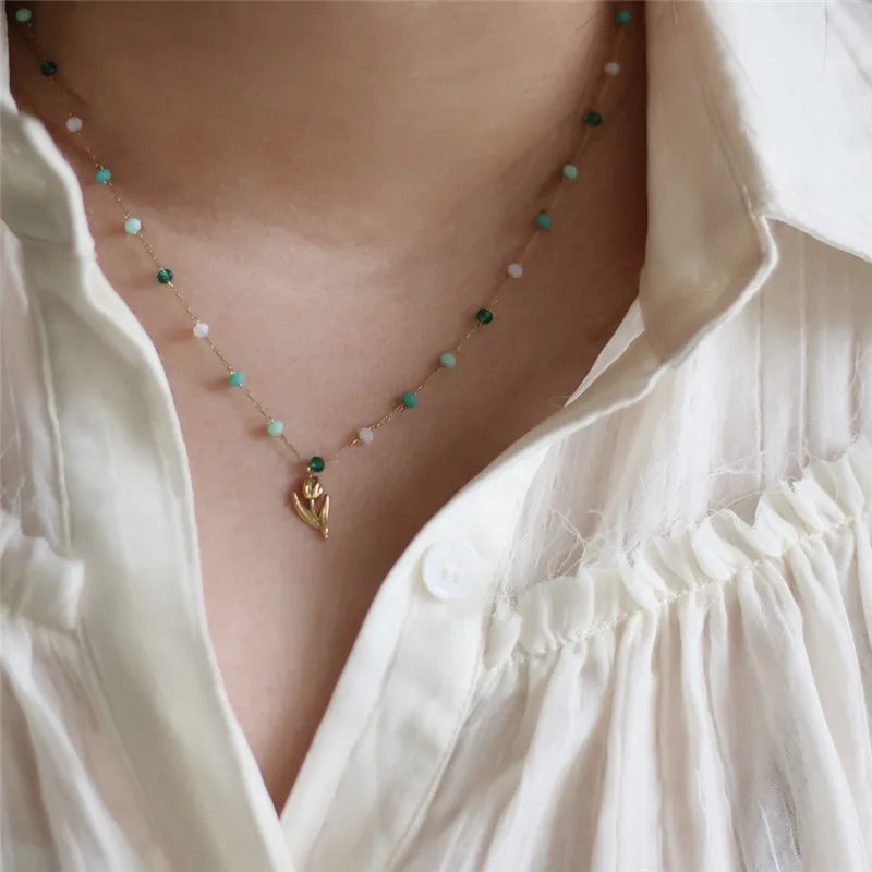 model wearing Stainless Steel Plated 18K Gold Fashion Interval Beads Tulip Pendant Necklace Women Small Fresh Versatile Jewelry