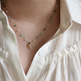model wearing Stainless Steel Plated 18K Gold Fashion Interval Beads Tulip Pendant Necklace Women Small Fresh Versatile Jewelry
