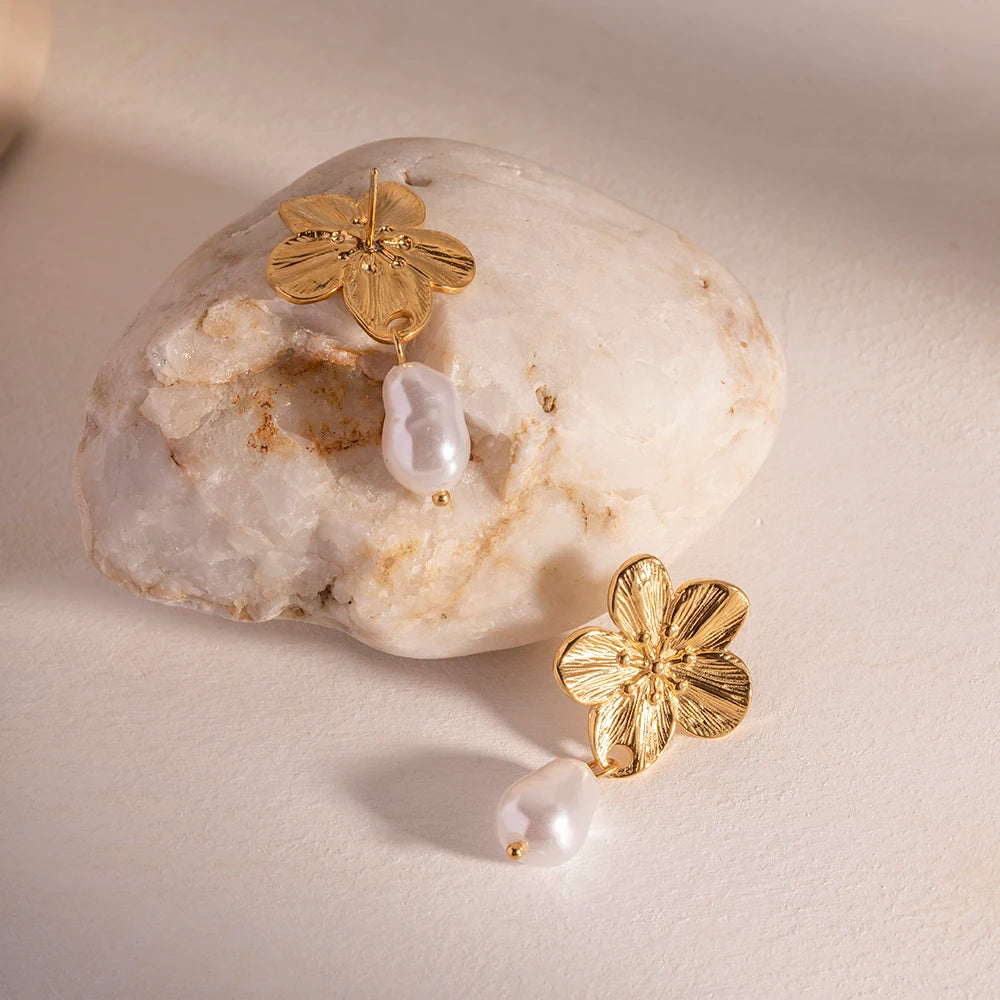 Displayed on a stone is a Waterproof Cherry Flower Pearl  stud Earrings - 18K Gold Plated