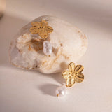 Displayed on a stone is a Waterproof Cherry Flower Pearl  stud Earrings - 18K Gold Plated