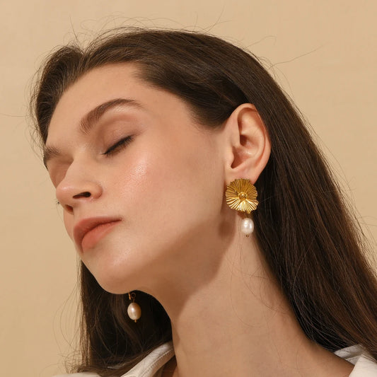 Elegant model wearing Waterproof Daisy Flower Stud Earrings with dangling fresh pearl - 18K Gold Plated