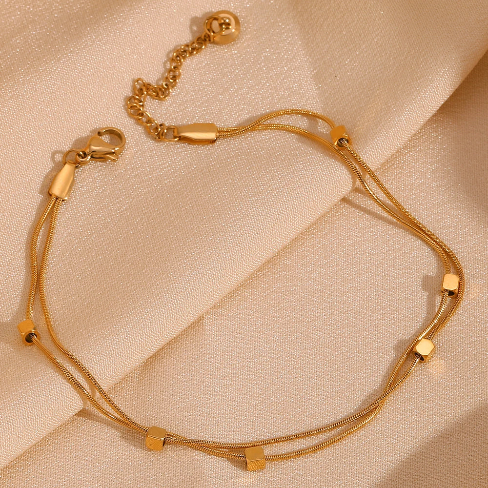 Waterproof Double Layer Anklet in 18K Gold Plated on a silk background