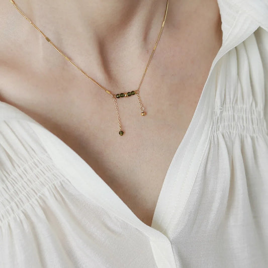 model wearing Waterproof Olive Green Beaded Tassel Necklace—18K gold-plated, lightweight, and elegant.