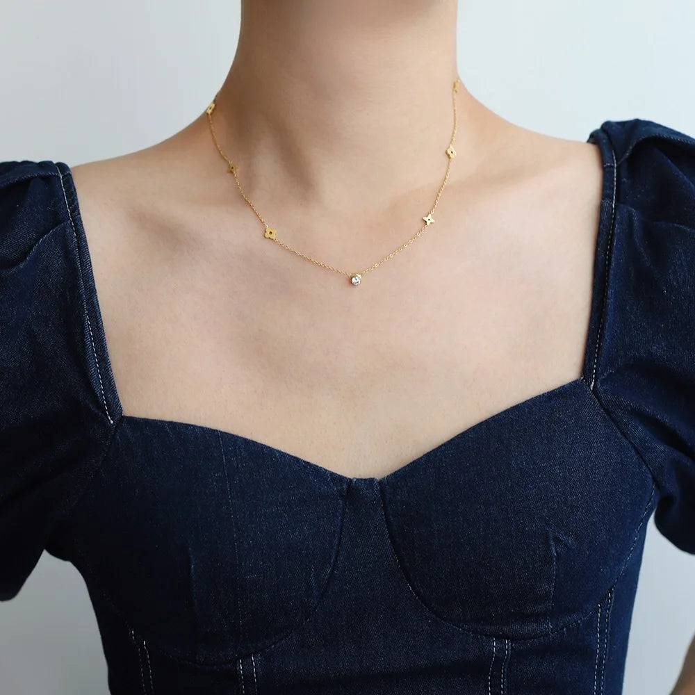 model wearing  Waterproof Zircon Flower Necklace in 18K Gold-Plated Stainless Steel