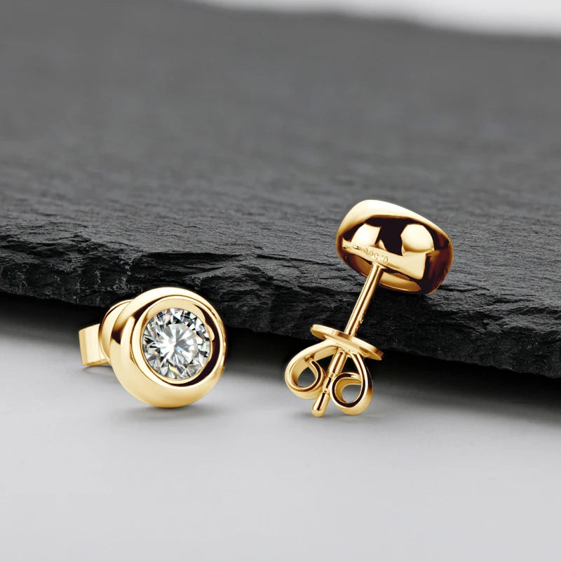 Bezel Moissanite Stud Earrings in 18K Yellow Gold Plated Silver displayed on a charcoal background