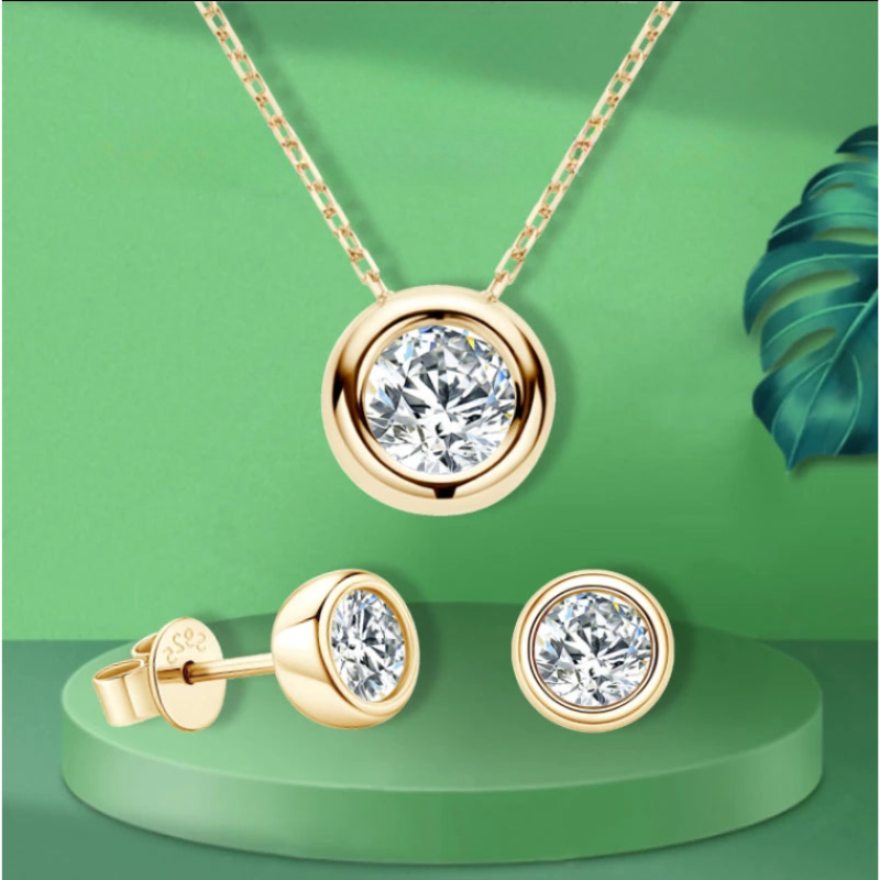 Bezel Solitaire Moissanite Jewelry Set in 18K Yellow Gold Plated Silver on a green background